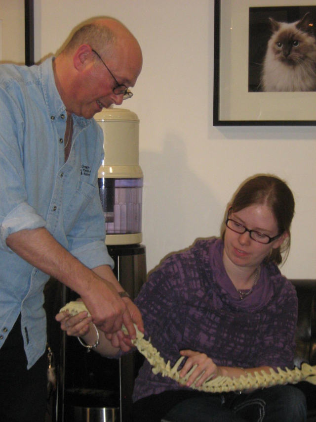 Dr. Goldberg and Jen demonstrating an adjustment on a dog's spine.